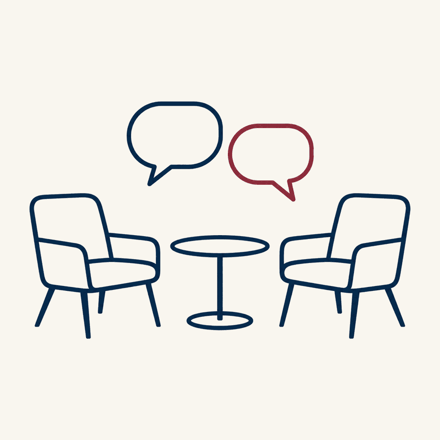 Two armchairs facing each other across a small round table with two speech bubbles above them, one in burgundy, illustrating a two-way conversation with your team